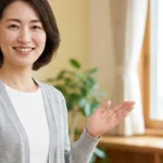 ヌーナン症候群のある子どもの入浴方法を紹介するライトグレーのカーディガンを着て微笑む女性アドバイザーの横長写真